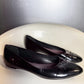 side view of vintage Louis Vuitton black patent leather ballet flats.