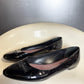 side view of vintage Louis Vuitton black patent leather ballet flats.