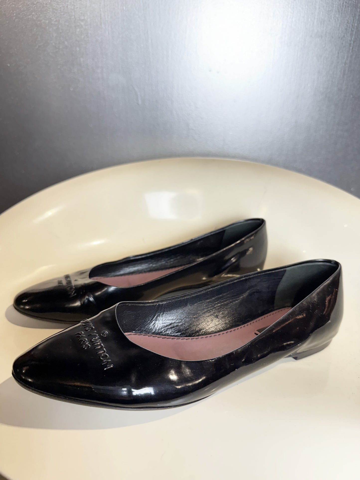 side view of vintage Louis Vuitton black patent leather ballet flats.