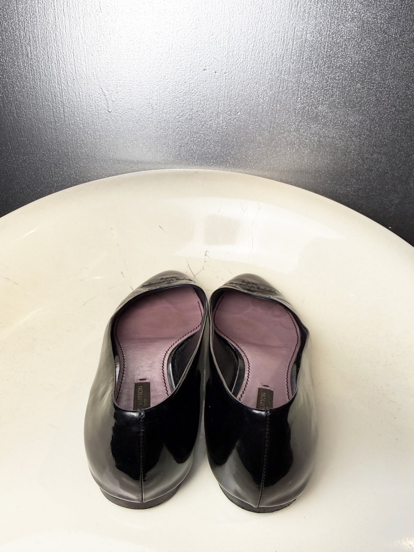 Back view of vintage Louis Vuitton black patent leather ballet flats.