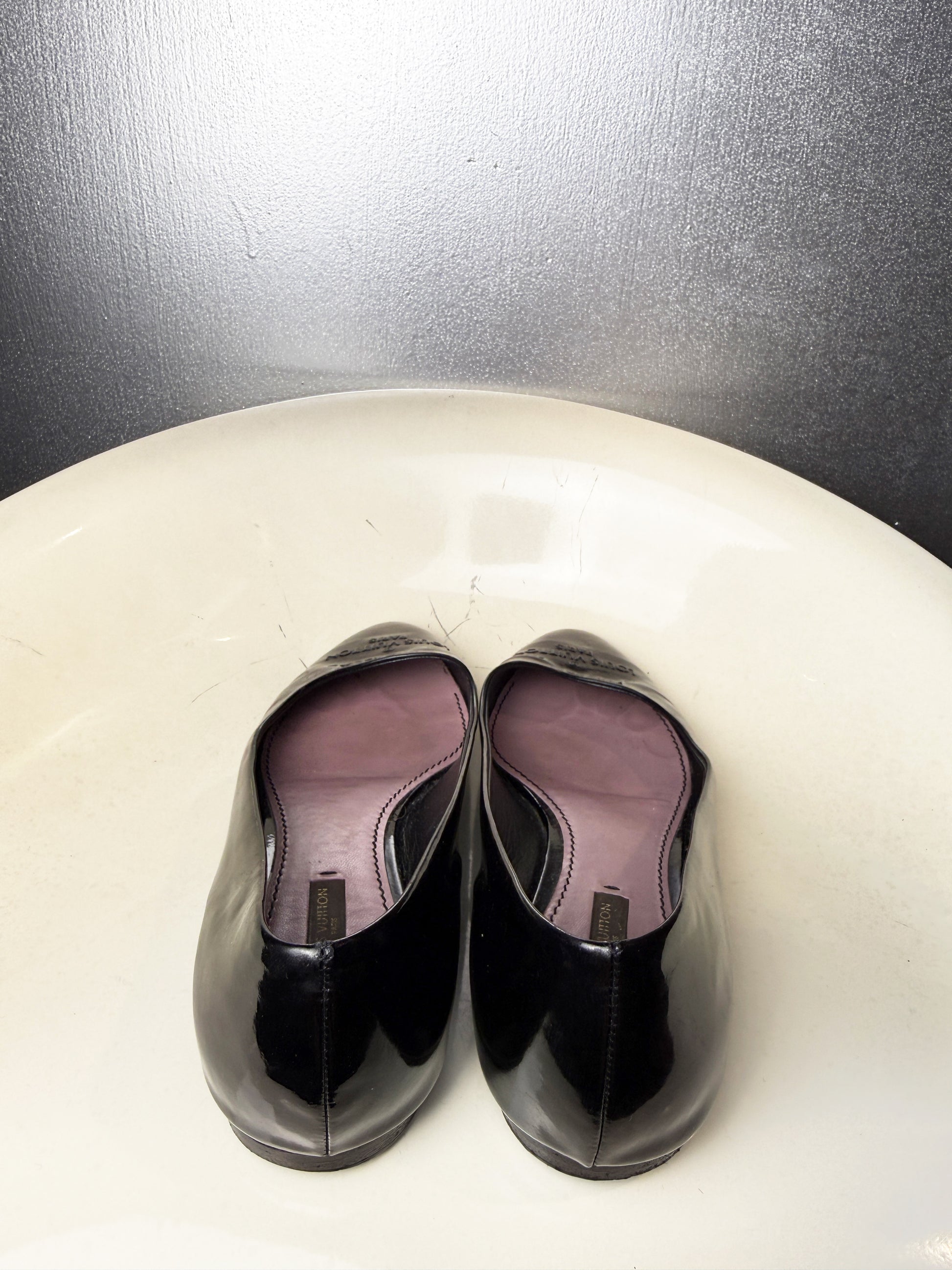 Back view of vintage Louis Vuitton black patent leather ballet flats.